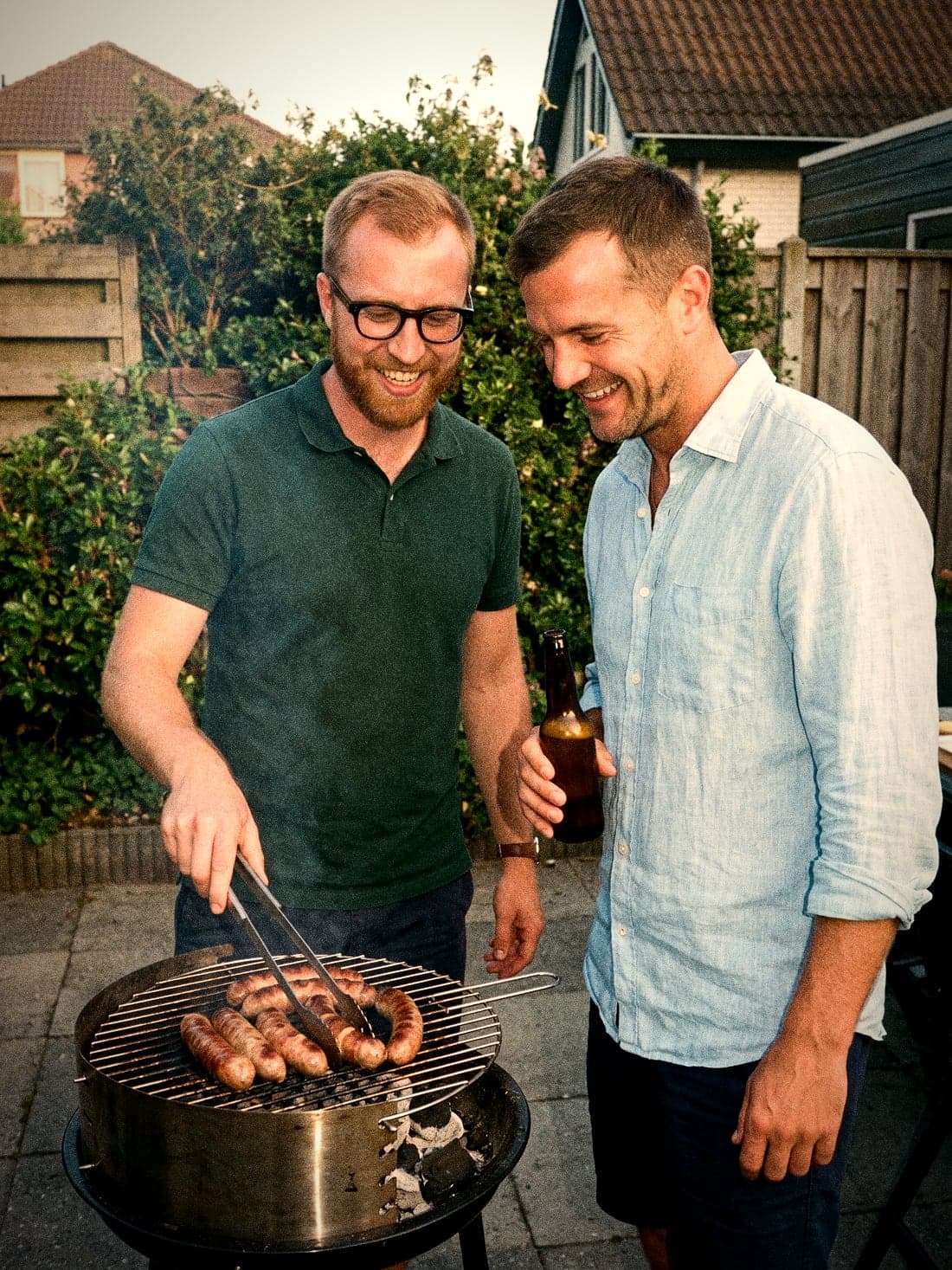 Joost at the barbecue, Mark watching and laughing