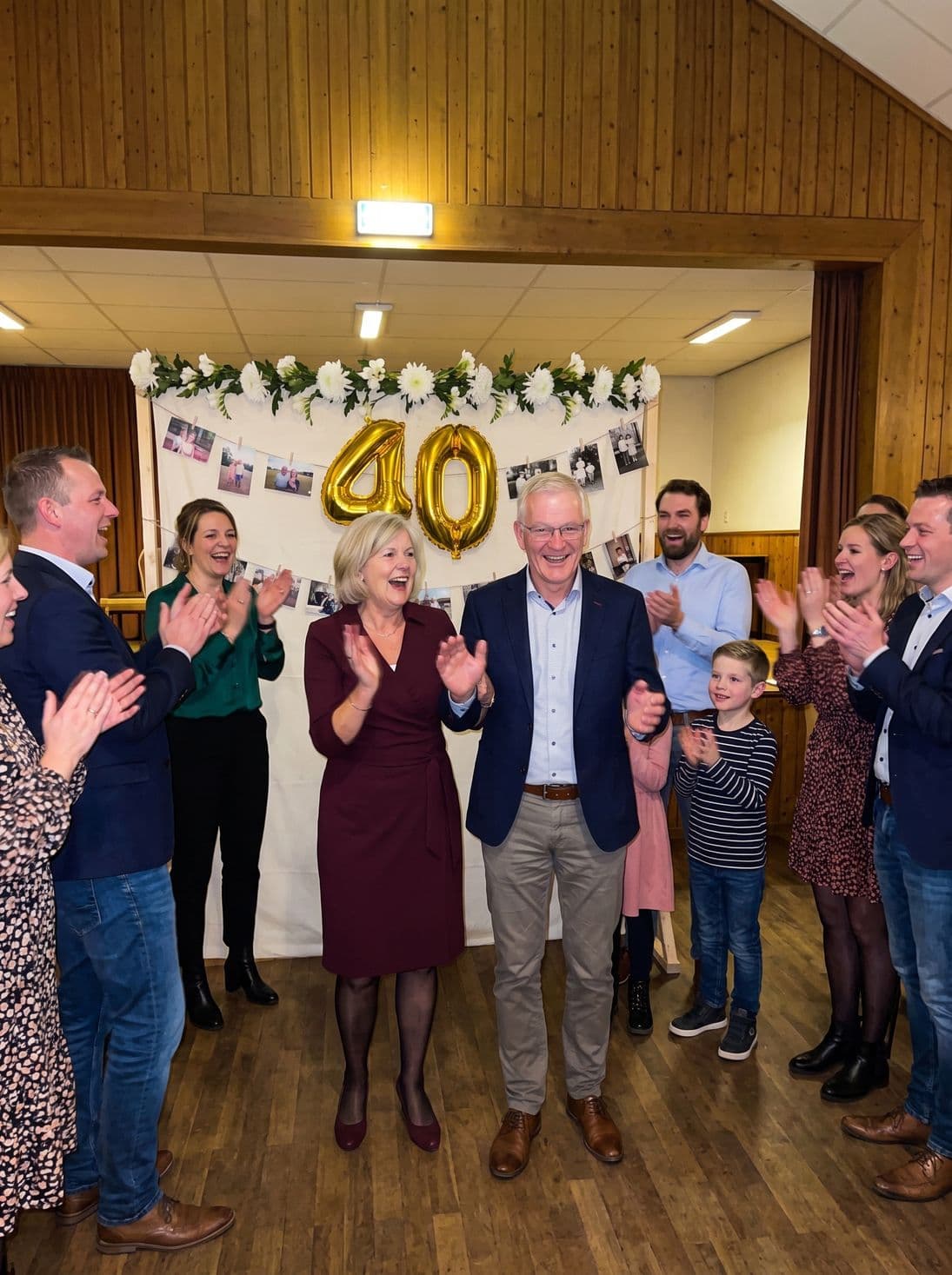 The anniversary couple enters the room while the guests applaud