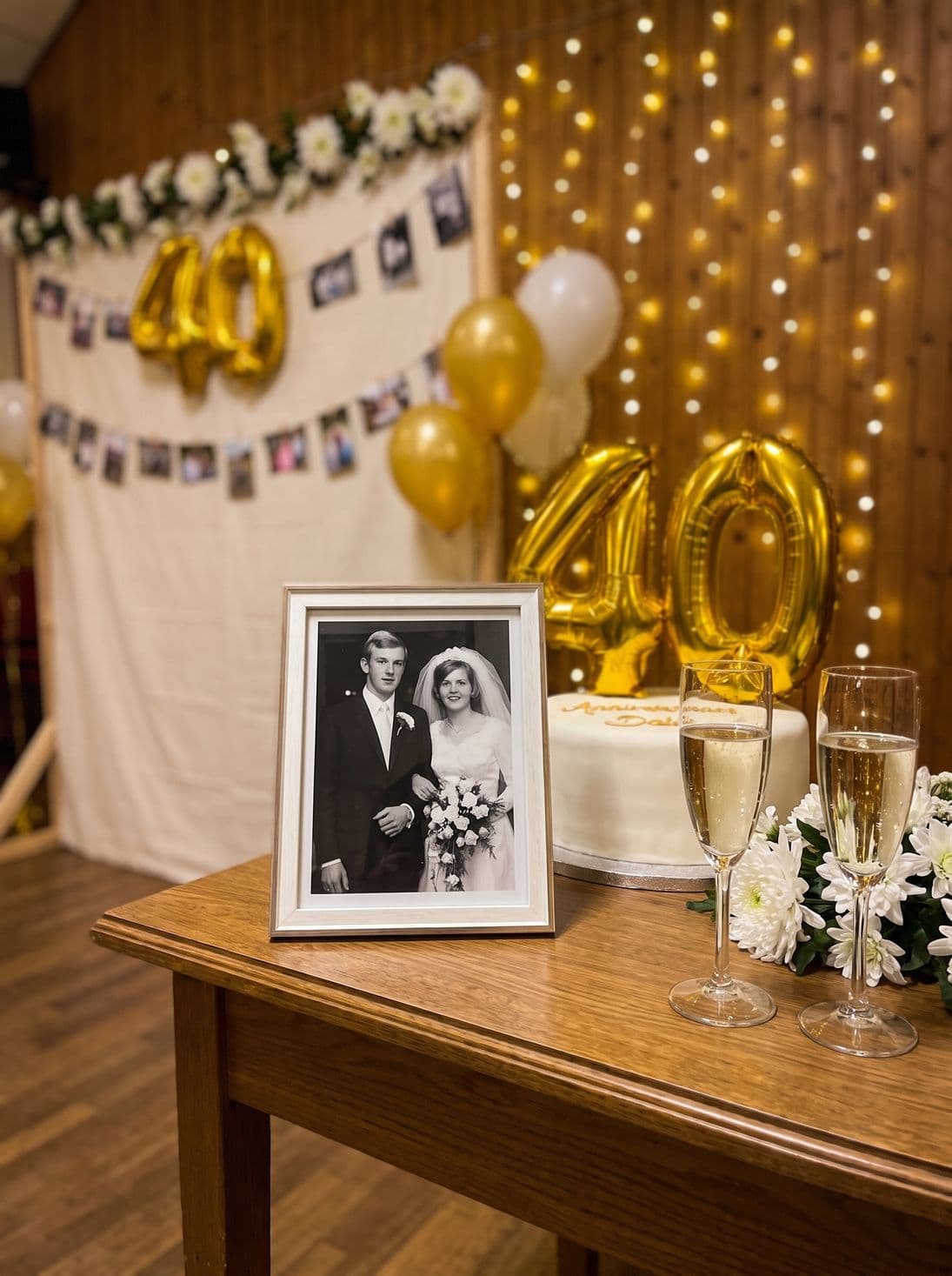 The old wedding photo next to the anniversary cake