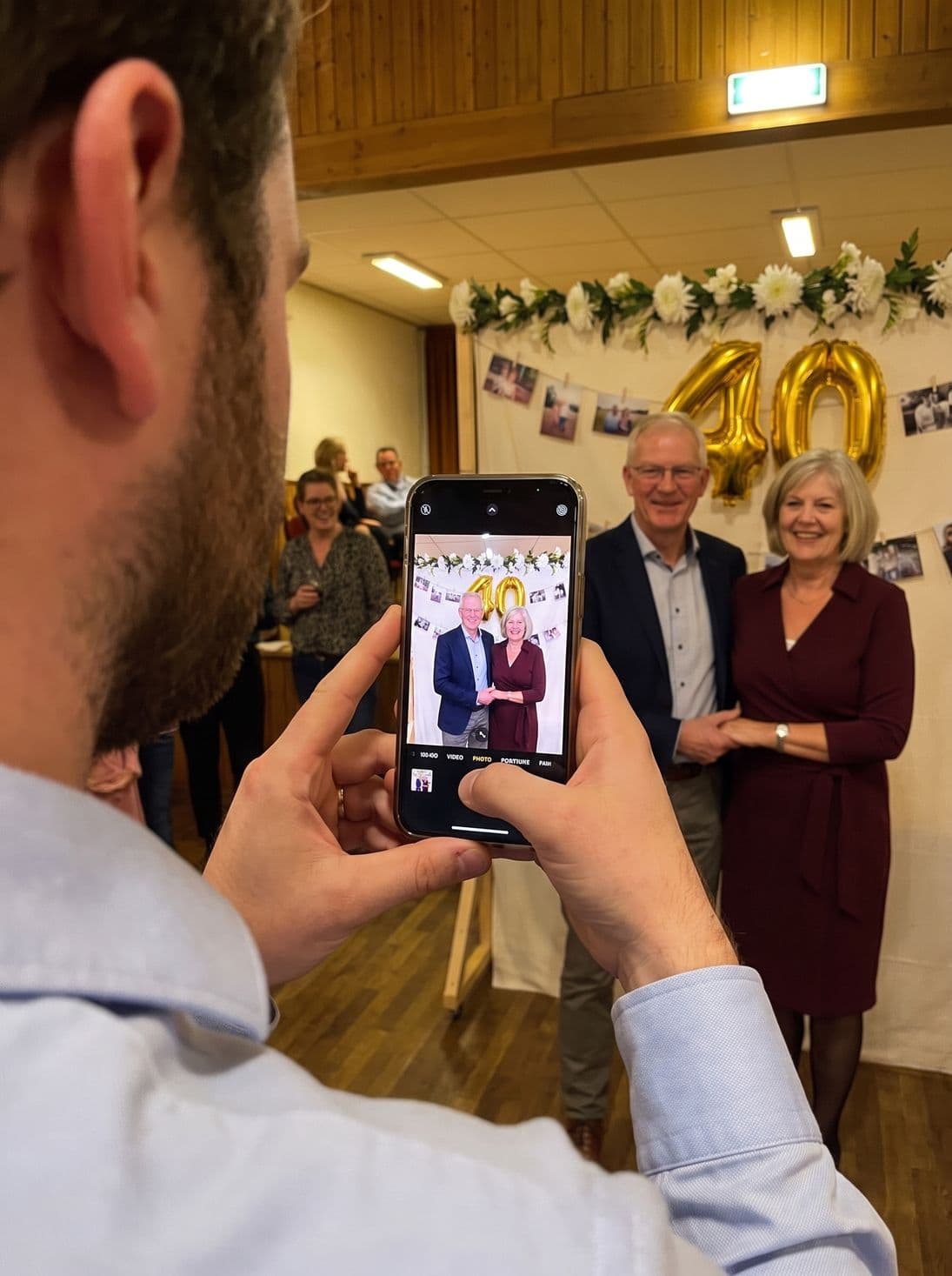 A guest photographs the couple in front of the 40 balloons