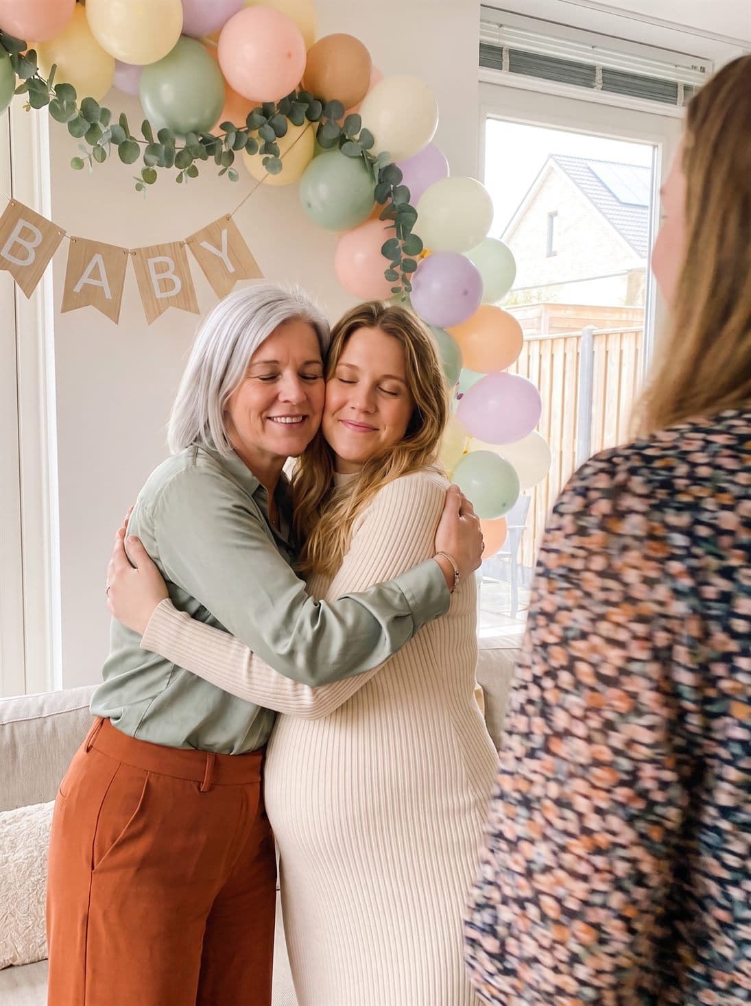 The grandma-to-be hugs her daughter
