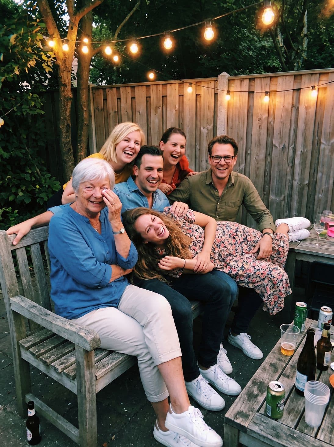 The whole group laughing on the garden bench
