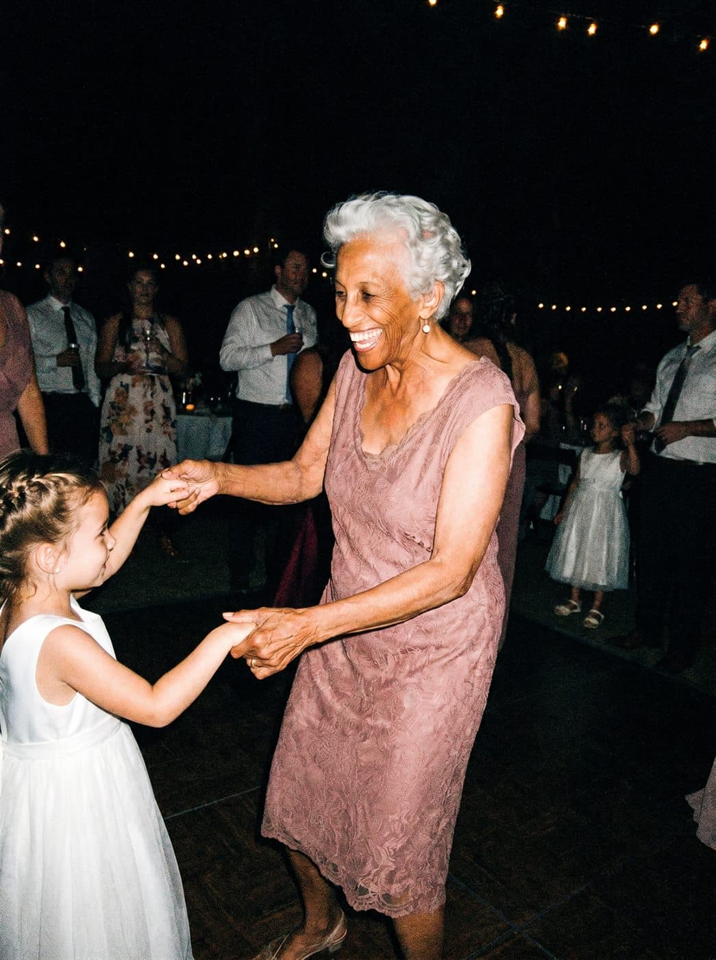 Gran dancing with the flower girl