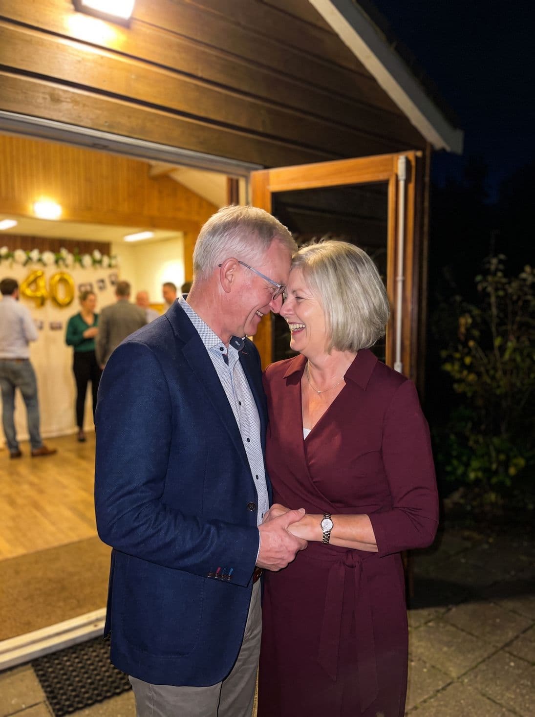 The couple outside the hall together, hand in hand