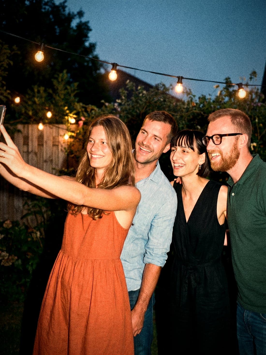 Group selfie under the string lights