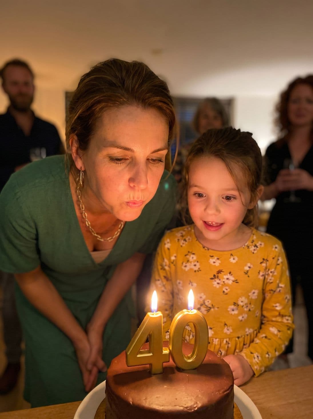 Blowing out the 40 candles with her daughter by her side