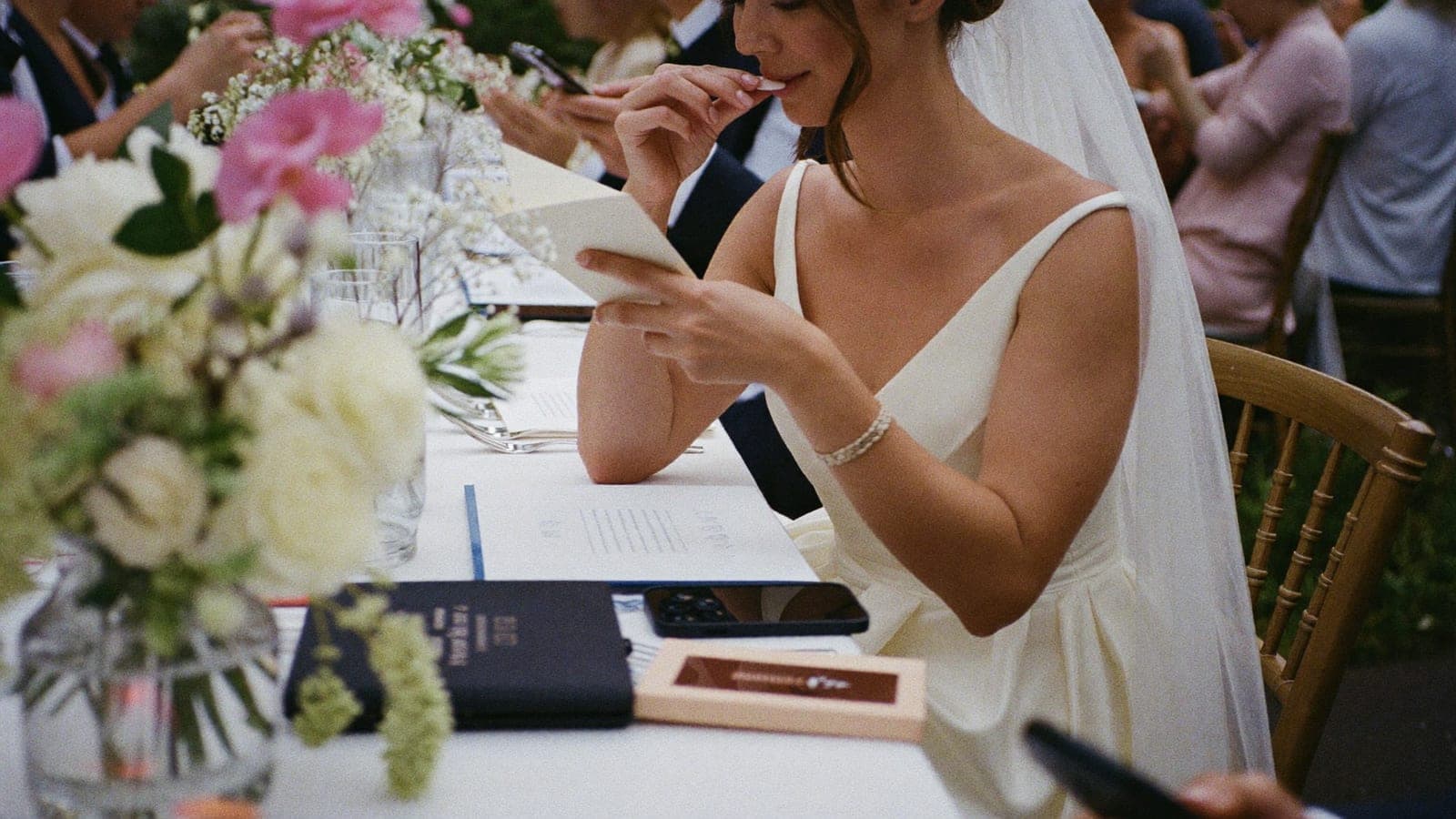 The bride reading the little card at her place setting