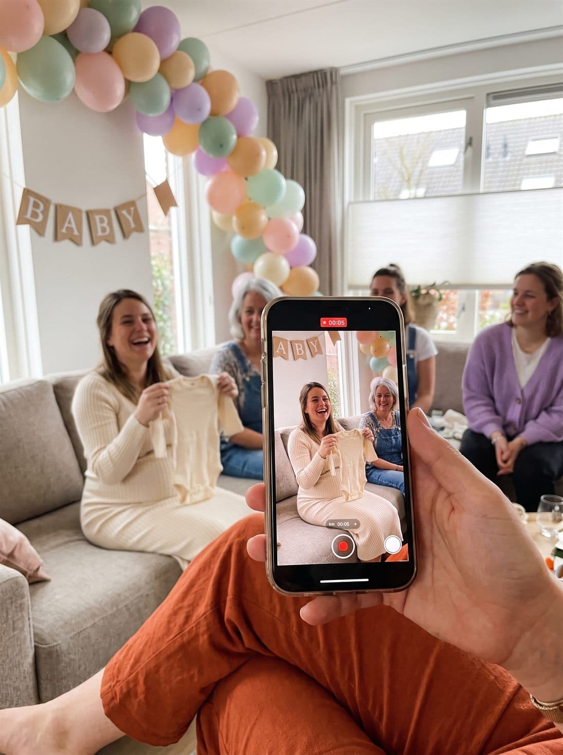 A friend films Noor unwrapping the baby outfit