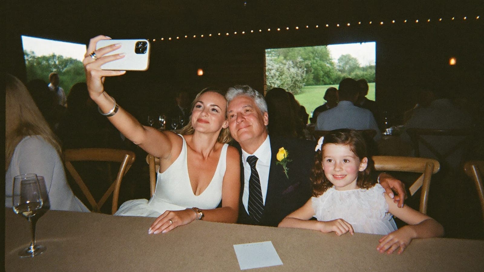 A playful selfie with the family at the wedding dinner table